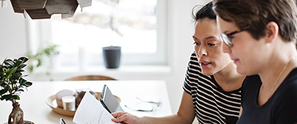 An entrepreneurial couple work through the TD procurement process while seated at their dining room table.