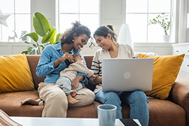 A TD colleague meets with a same-sex couple in a branch office to discuss their finances.