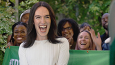 Club Quarantine co-founder Ceréna celebrates with a crowd in front of a TD banner.