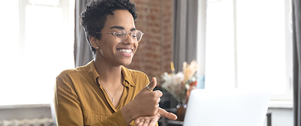 A female customer uses sign language to communicate with an advisor through the TD video relay service.